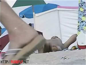 Beach bombshells drape out naked below the sun